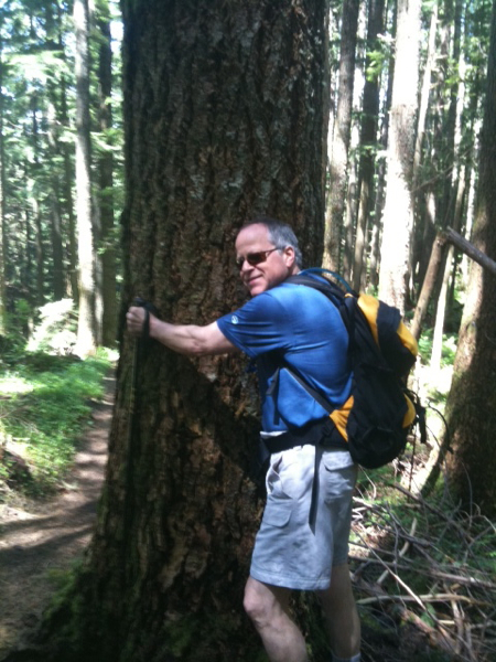 Marty Carr gets next to a Douglas fir on the Rattlesnake Mountain trail, near North Bend, Washington.