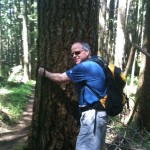 Marty Carr gets next to a Douglas fir on the Rattlesnake Mountain trail, near North Bend, Washington.